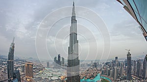 Paniramic skyline view of Dubai downtown with mall, fountains and Burj Khalifa aerial day to night timelapse