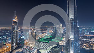 Paniramic skyline view of Dubai downtown with mall, fountains and Burj Khalifa aerial night timelapse