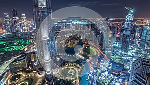 Paniramic skyline view of Dubai downtown with mall, fountains and Burj Khalifa aerial night timelapse