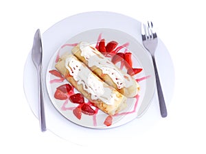 Pankcake with cream , with rolled fruit inside.