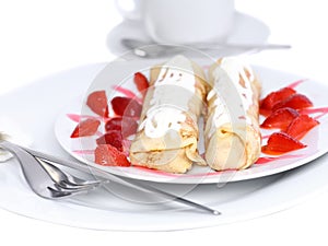 Pankcake with cream , with rolled fruit inside.