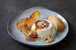 Panna cotta with caramelised pineapple and coconut biscuit photo