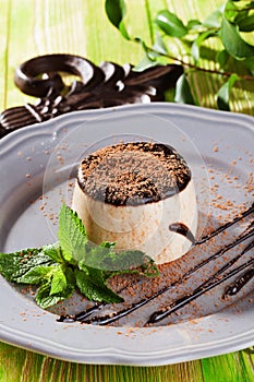 Panna cotta with cocoa, chocolate, still life plate style Provence, a wooden table, board, beautiful, elegant