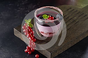 Panna cotta dessert in a glass on rustic wooden background.