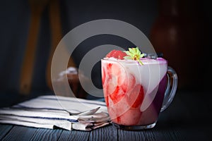 Panna-cotta, dessert. Jelly, whipped cream pudding of berries and gelatin. A cupcake, a rough cloth napkin and a dessert spoon. Pi