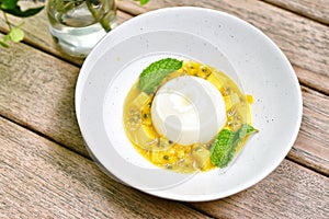 Panna cotta with sweet mango and fresh passion fruit, Refreshing Italian dessert