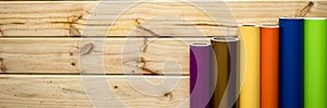 Panned colorful vinyl rolls on wooden background photo