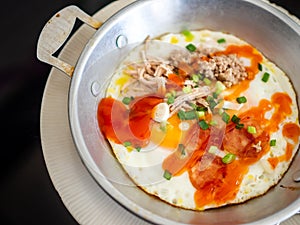 Panned egg food with sausage and pork chops in a metal dish photo