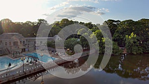 panning aerial footage of a gorgeous summer landscape at Piedmont Park with the rippling waters of Lake Clara Meer