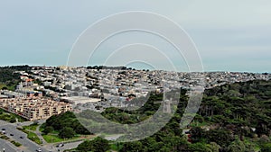 panning aerial footage of homes along a hillside and lush green trees and plants a Golden Gate Park, Queen Wilhelmina Garden