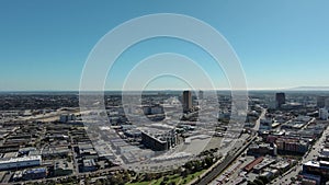 panning aerial footage of skyscrapers, hotels and office buildings downtown with cars and trucks driving on the street