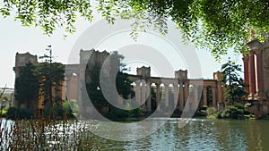 panning footage of a beautiful spring landscape at Palace of Fine Arts with a lake, lush green trees and plants