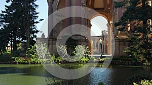 panning footage of a beautiful spring landscape at Palace of Fine Arts with a lake, lush green trees and plants