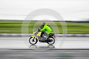 Panning shot of bike rider during monsoon season at pulwama kashmir