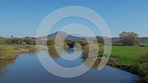 A panning shot over the River Severn in Cressage, Shropshire, looking towards the Wrekin Hill, a local landmark