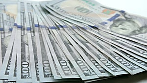 Panning shot over US 100-dollar bills