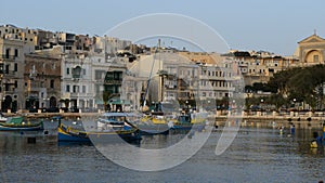 The panning of traditional Maltese boats in sunset