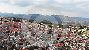 Panning view popular tourist attraction Pano Lefkara village on Cyprus, Europe. Flying over majestic cityscape with greek orthodox