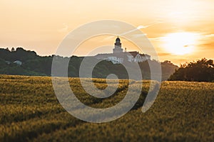 Pannonhalma Archabbey with wheat field and path on sunset in Hungary photo