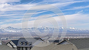 Pano Aerial landscape of neighborhood in Utah Valley with houses and snowy mountain