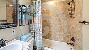 Pano Bathroom interior with antique fixtures and ceramic tile walls