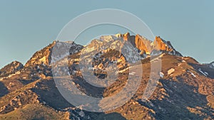 Pano frame Scenic view of a mountain peak with rugged slopes and dusted with snow