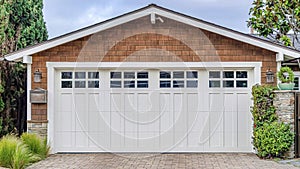 Pano Garage in San Diego California with white door and brown wall under gable roof