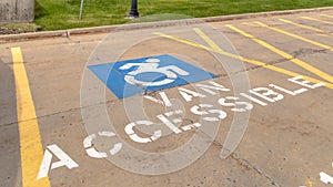 Pano Handicapped parking lot with painted handicap symbol and Van Accessible sign