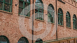 Pano Restaurant exterior in Park City with red brick wall and green arched windows