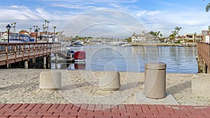 Pano Scenic sea with boat docks under vibrant blue sky in Huntington Beach California