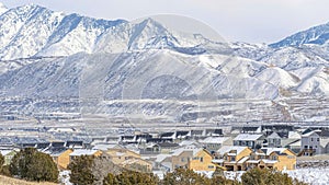 Pano Snowy mountain and aerial view of houses in Utah Valley neighborhood in winter