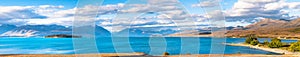 Panolama view of Beautiful scene of blue lake, yellow grassland, mt cook and blue blue sky with cloud beside lake Tekapo before