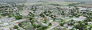 Panorama aerial view agriculture agro-town with residential houses, church buildings, small local business surrounding photo