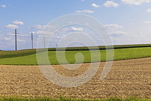 Panorama aerial view of the green Swiss hills on a summers day with blue sky