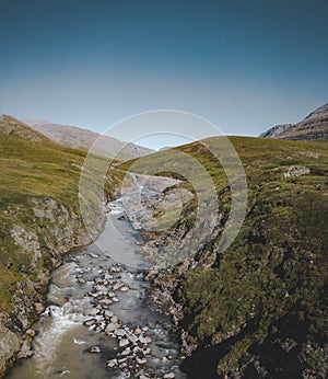 Panorama aerial view of a hiking area in a rocky environment with arctic meadows in summer. River on Island of kuannit