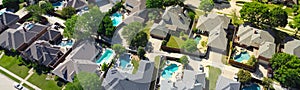 Panorama aerial view lush greenery suburban residential neighborhood subdivision, row upscale two-story houses, swimming