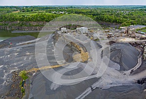 Panorama aerial view open-pit mining quarrying extractive industry at opencast mining with lots of machinery trucks