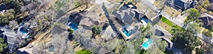 Panorama aerial view upscale two story house with circular driveway, swimming pool, large backyard, suburban low density housing