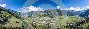 360 Panorama Aerial view of Zillertal Valley village in sunny summer afternoon in Tyrol Austria photo