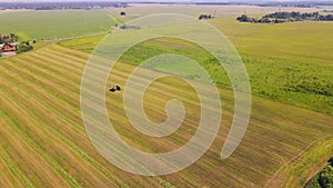 Panorama, agricultural machinery is harvesting in the field, aerial view.