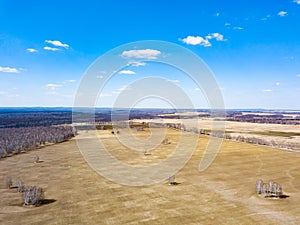 Panorama from the air on the lush meadows and fields with colorful plots of agricultural crops before sowing in spring outside the
