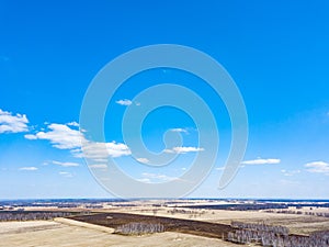 Panorama from the air on the lush meadows and fields with colorful plots of agricultural crops before sowing in spring outside the