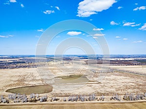 Panorama from the air on the lush meadows and fields with colorful plots of agricultural crops before sowing in spring outside the