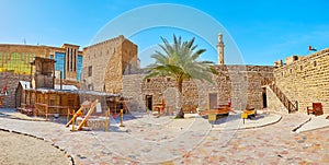 Panorama of Al Fahidi Fort with historic arish summer house and fishing boats, Dubai, UAE