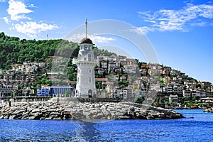 Panorama of Alanya with a white old lighthouse in the foreground - view from the Mediterranean