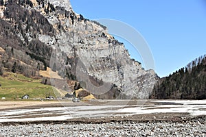 Panorama of Alps from the bottom of partly dried-up  KlÃÂ¶ntalersee lake covered with snow and ice photo