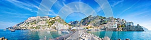 Panorama of Amalfi on hills leading down to coast, comfortable beaches and azure sea on Amalfi Coast in Campania, Italy