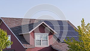 Panorama Array of photovoltaic solar panels on a roof