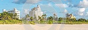 Panorama of Art deco district of South Beach Miami. The buildings are surrounded by tropical palm trees.