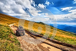 Panorama ATV Quad Bike riders on beautiful mountain landscape